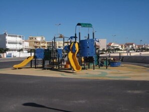 A playground with slides and climbing structures.