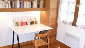 A study area with a desk, chair, bookshelf, and a Union Jack rug.