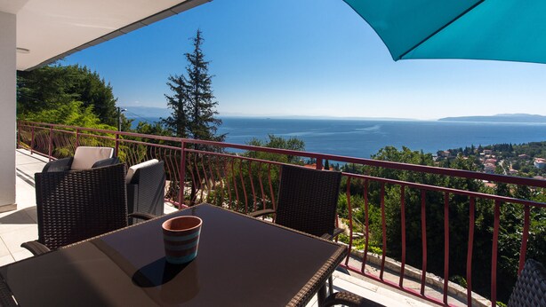 A balcony with wicker chairs and a table, overlooking a scenic view of the sea and distant hills. - Villa Capra Verde - private pool, oasis of peace, 150 m as the crow flies to the sea, Opatija  (Icici)