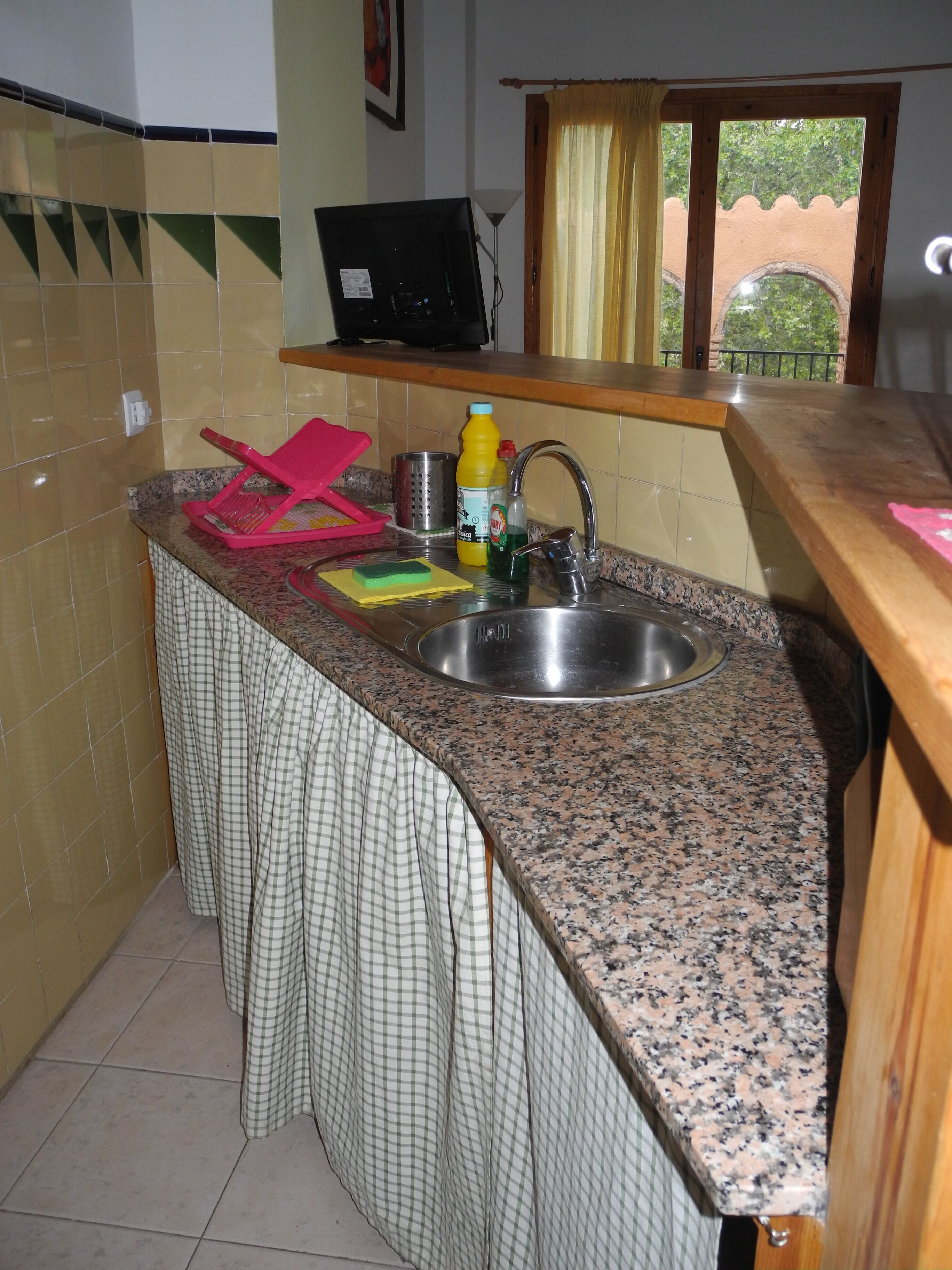 Corn rose with air and light overlooking the treetops of the village well