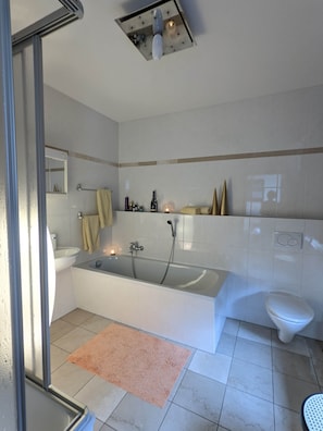Bathtub, hair dryer, towels, soap