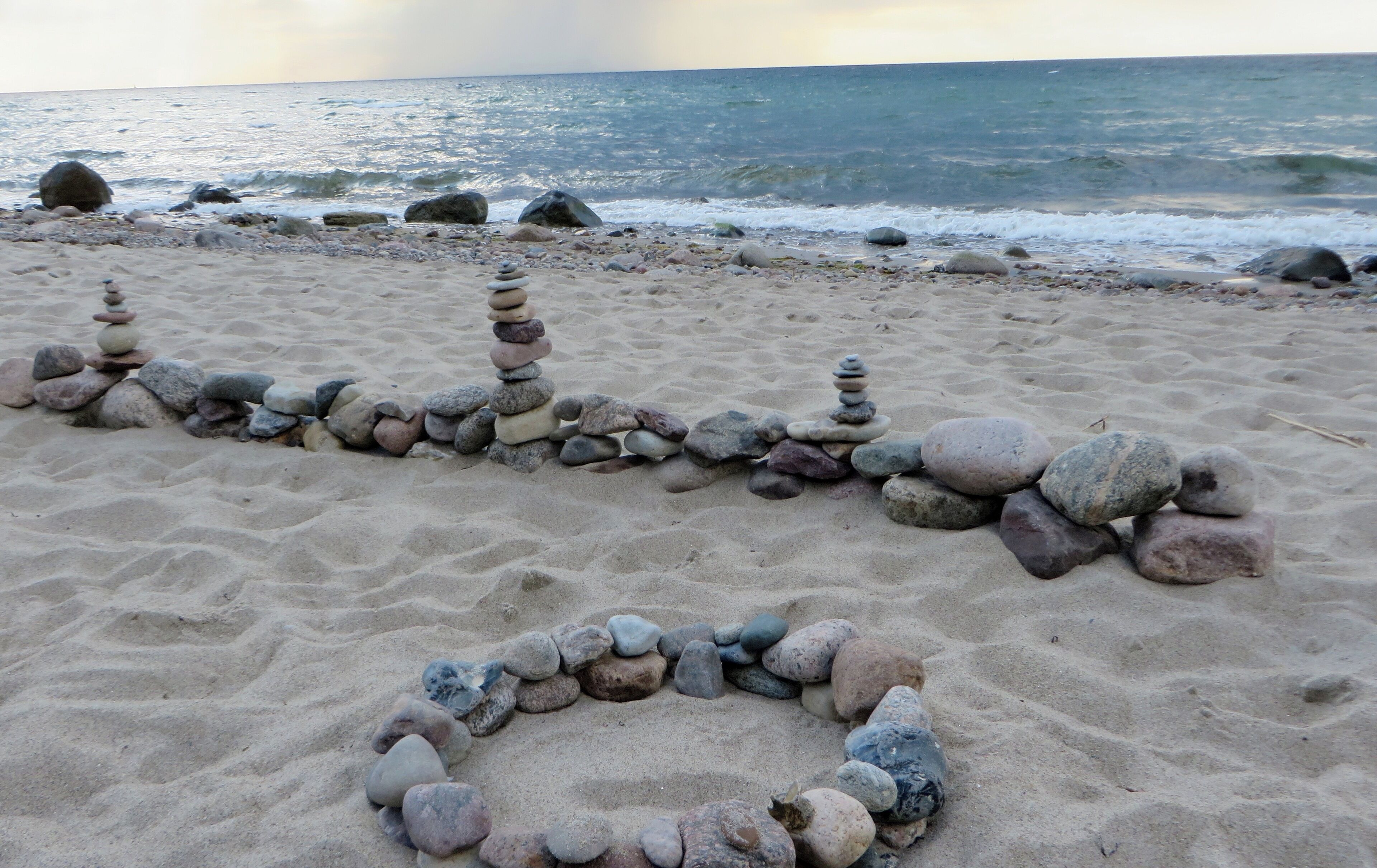 A beach with a stone arrangement.