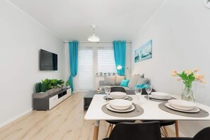 Enjoy meals in this stylish dining area with a table for four, console table, and flat-screen TV.