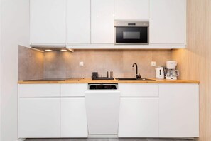 Enjoy cooking in this kitchen with oven, coffee maker, and dishwasher.