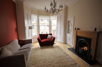 cosy lounge with open fire and bay window