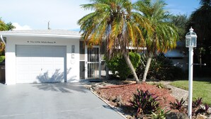 A single-story house with a garage labeled "The Little White House." - Top location, heated privat pool, Wi-Fi, Tropical Garden, Child- and petfriendly (Cape Coral)