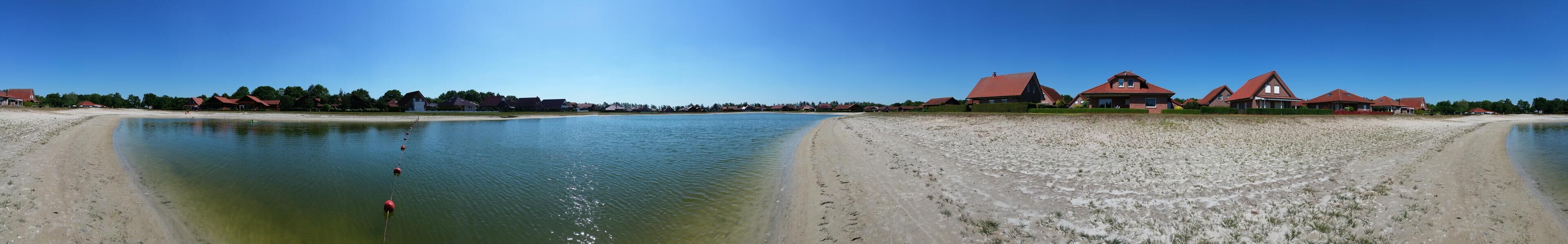 A coastal area with houses and a beach.