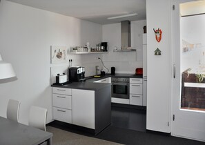 Fridge, stovetop, dishwasher, coffee/tea maker