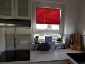 Fridge, stovetop, dishwasher, coffee/tea maker