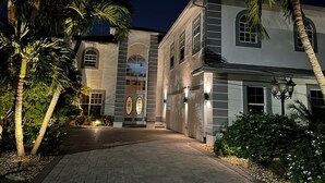 A large, two-story building with a symmetrical facade, large windows, and a central arched entrance. - *** Luxurious Villa at River ***  (Florida)