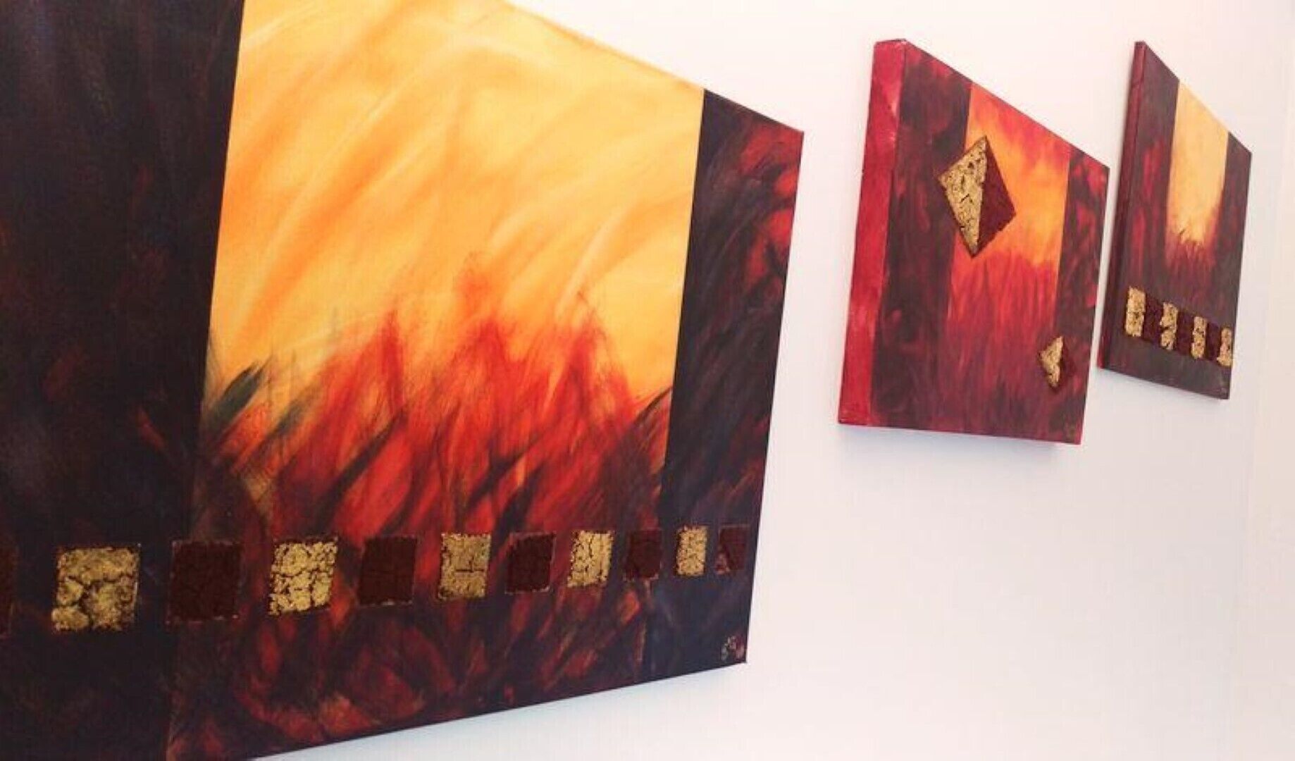 Three artworks with abstract designs and gold accents.