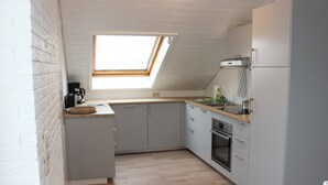 A compact kitchen with grey cabinets, a wooden countertop, and a skylight. - modern, very spacious apartment in the immediate vicinity of the Center Parcs (Medebach)