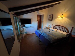 A bedroom with a bed, a chair, a desk, and a TV. - Holiday house with pool, garden, ca. 1 km to beach, tranquil, south-facing (Jávea)