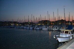 A marina at dusk with numerous boats docked. - Our vacation home is located on the promenade & on the beach of Gruissan. (Gruissan)