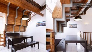 A modern interior with a dark wooden table and bench, white tiled flooring, and a geometric wooden ceiling design. - Vieux Port to Notre Dame de la Garde Triplex 70 m2 terrace (Marseille)