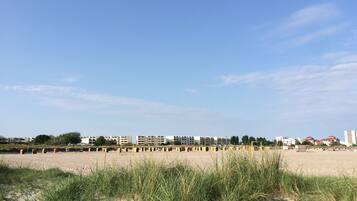 A beach with a row of buildings in the background.