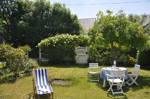 Enjoy a peaceful meal in a secluded garden setting, surrounded by lush greenery and a tranquil atmosphere.