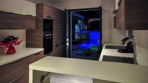 A modern kitchen with a built-in oven, a sink, and a countertop. - Villa with 2 private pools - close to the beach (Bompas)