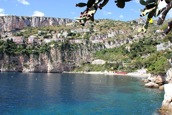 A coastal town with buildings on a cliff overlooking the sea.