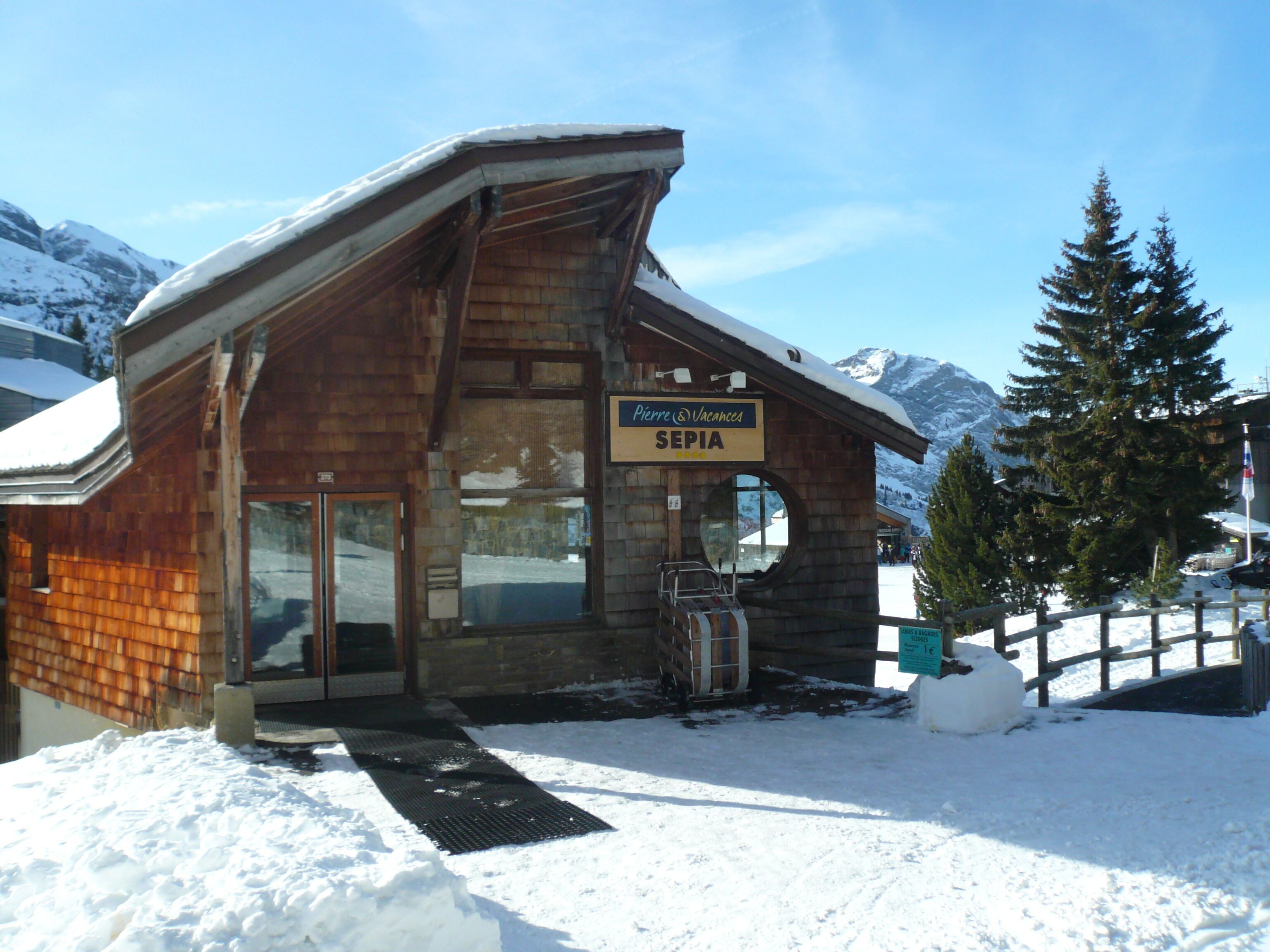 A wooden building with a sign reading "Pierre & Vacances SEPIA."