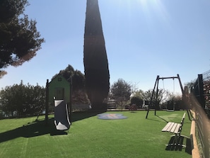 A playground with a slide, swing set, and a small green building. - ✨ Comfort & sun in Nice 🌞 | Terrace sea view, pools & tennis (Nice)