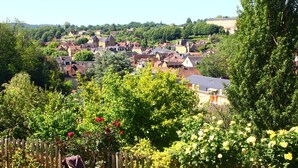 A residential area with houses, a wooden fence, and a garden with flowers.