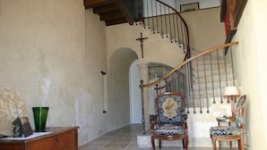 A staircase with a wooden handrail and a metal banister, leading to an upper floor. - Château near the Puy du Fou, in the heart of the Vendée bocage (Sèvremont)