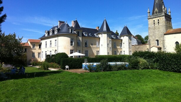 A large, historic building with multiple towers and a well-maintained garden. - Château near the Puy du Fou, in the heart of the Vendée bocage (Sèvremont)