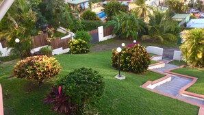 A well-maintained garden with various plants and a small gazebo.
