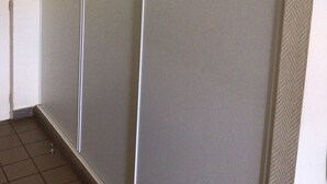A hallway with a sliding door and a tiled floor.