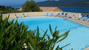 A swimming pool with blue lounge chairs and a view of the sea and mountains. - Resa 2025 open! SUPERB SEA VIEW mini villa heated pool Serra di Ferro (Serra-Di-Ferro)