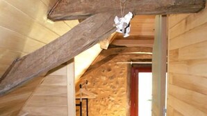 A wooden interior with a sloped ceiling, a stone wall, and a wooden floor. - Charming cottage, private turquoise pool, PLAZAC-prox. treasures of Périgord (Plazac)