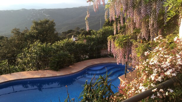 A swimming pool with a view of a mountainous landscape.