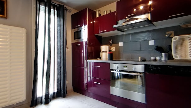 A modern kitchen with stainless steel appliances, a built-in oven, and a microwave. - Luxury house close to Disney & Paris wifi & breakfast free.  (Noisiel)