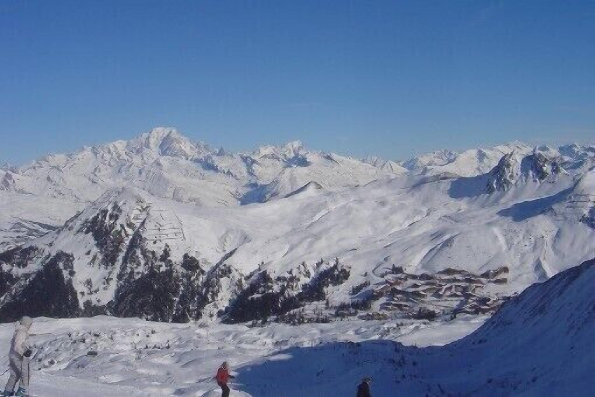 A snow-covered mountain landscape with a clear sky.