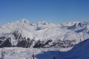 A snow-covered mountain landscape with a clear sky.