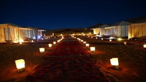 A desert camp with tents arranged in rows, a central pathway with lanterns, and a clear night sky. - 3- Sweet Erg Chebbi Merzouga (Merzouga)