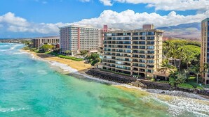 A coastal hotel with multiple high-rise buildings, a beach, and ocean views.