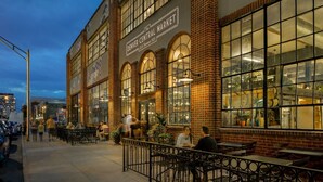 A historic building with large windows and a brick facade, featuring outdoor seating and a visible storefront. - Exceptional and artful, modern Victorian. Very centrally located. Dog friendly! (Denver)