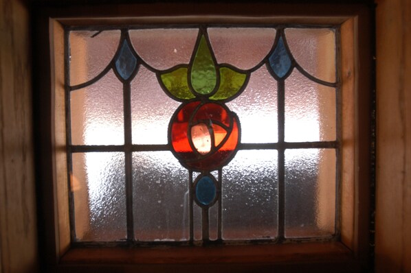 A stained glass window with a floral design.