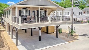 A single-story building with a covered patio area and a small deck.