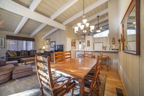 Spacious dining area, seats 8 at table, 3 at bar