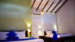 A hotel room with two beds, a ceiling fan, and wall-mounted lights. - Tenasi Beach Resort (Ahangama)