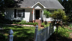 A white house with a dark roof, a front porch, and a flag. - Yadkin Valley has the same viticulture stamp as NAPA.  Canoes and Kayaks!! (Elkin)