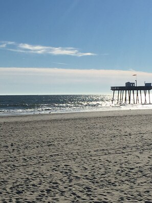A beach with a pier extending into the ocean. - Four Blocks To Beach & Boardwalk  + Pet Friendly (Ocean City)