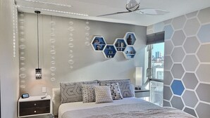 A modern bedroom with a large bed, a desk, and a city view. - Rooftop Retreat-modern townhome in the heart of LoHi- roof deck-walk everywhere! (Denver)