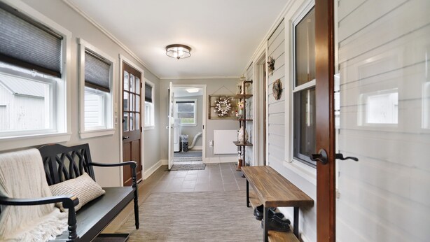 A hallway with a bench, a table, and a door. - Near Whitetail, Berkeley Springs, Mercersburg, Hagerstown, Antietam, Frederick (Big Cove Tannery)