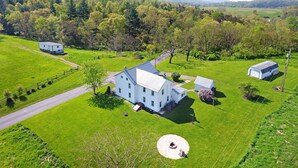 A large, single-story house with a spacious lawn, a small shed, and a well-maintained garden. - Near Whitetail, Berkeley Springs, Mercersburg, Hagerstown, Antietam, Frederick (Big Cove Tannery)