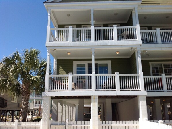 A two-story building with a balcony on the second floor.