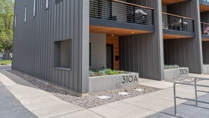 A modern building with a grey facade, wooden accents, and large windows. - 
Townhome with Stunning Views & Modern Finishes (Missoula)